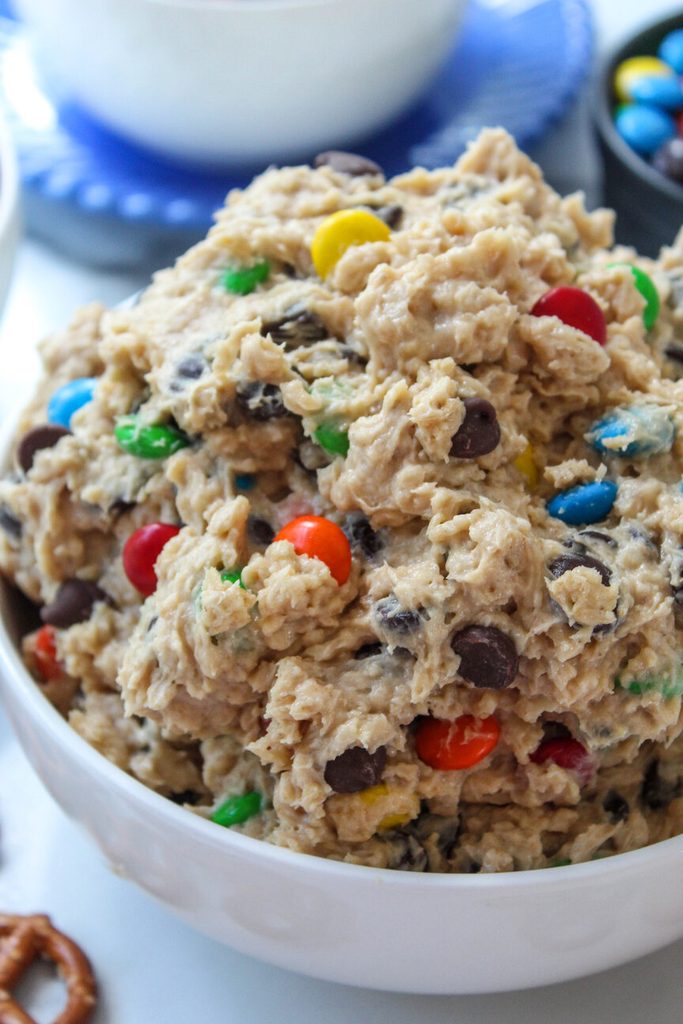 Bowl of monster cookie dough dip with oats, peanut butter, and candy pieces