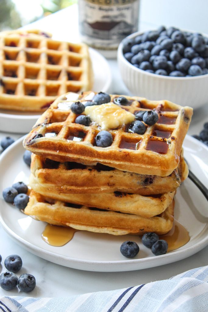 Fluffy blueberry waffles with crisp golden edges and juicy berries