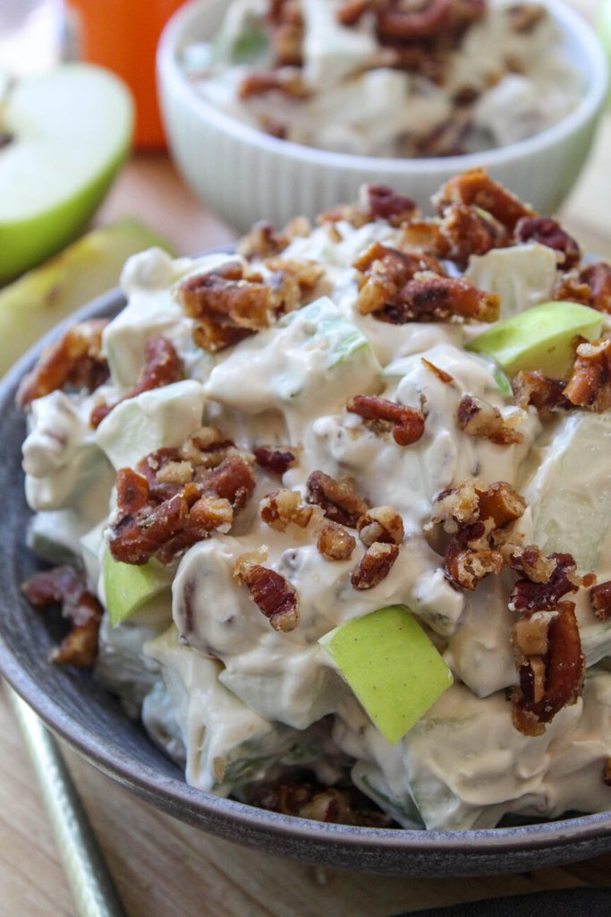Caramel apple crackle salad in a bowl topped with crunchy toffee pieces