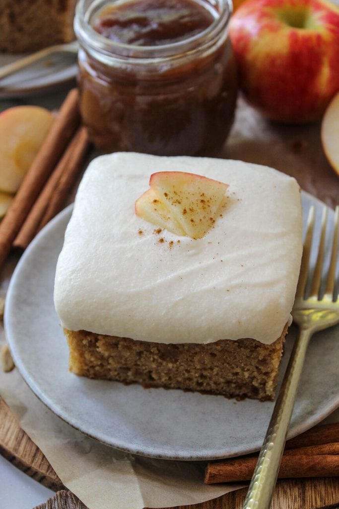 Thick slice of apple butter cake served on a cozy fall plate