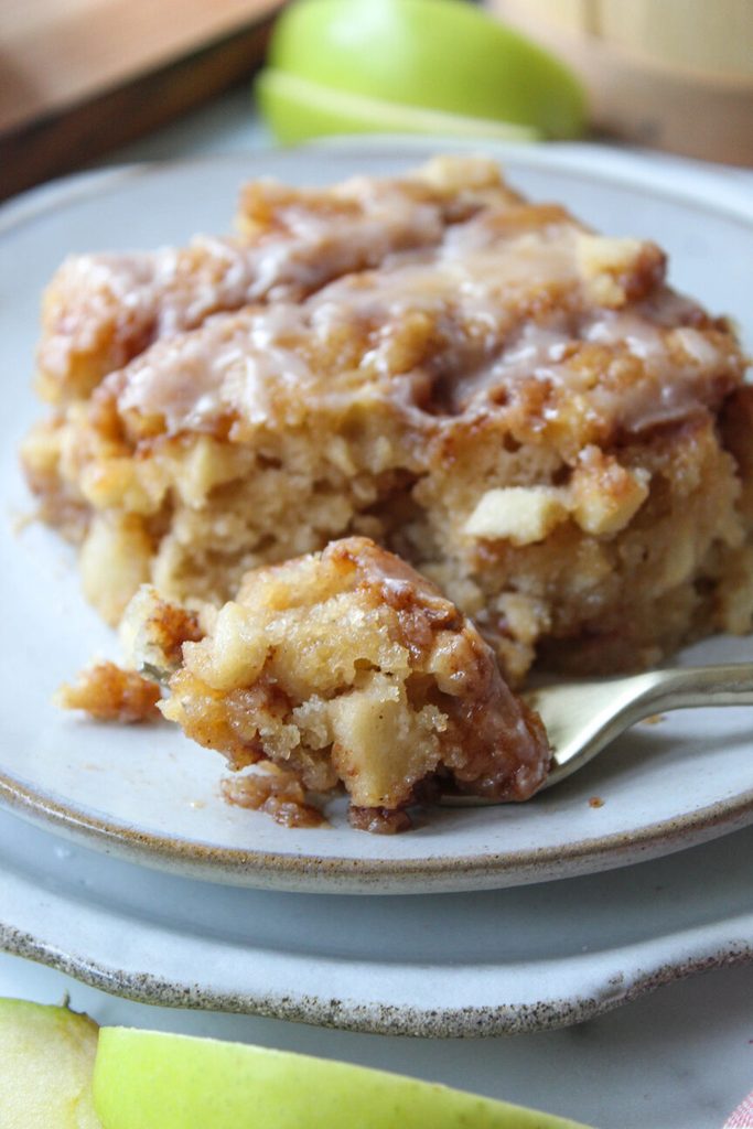 fall‑themed apple fritter cake with shiny glaze and apple pieces

